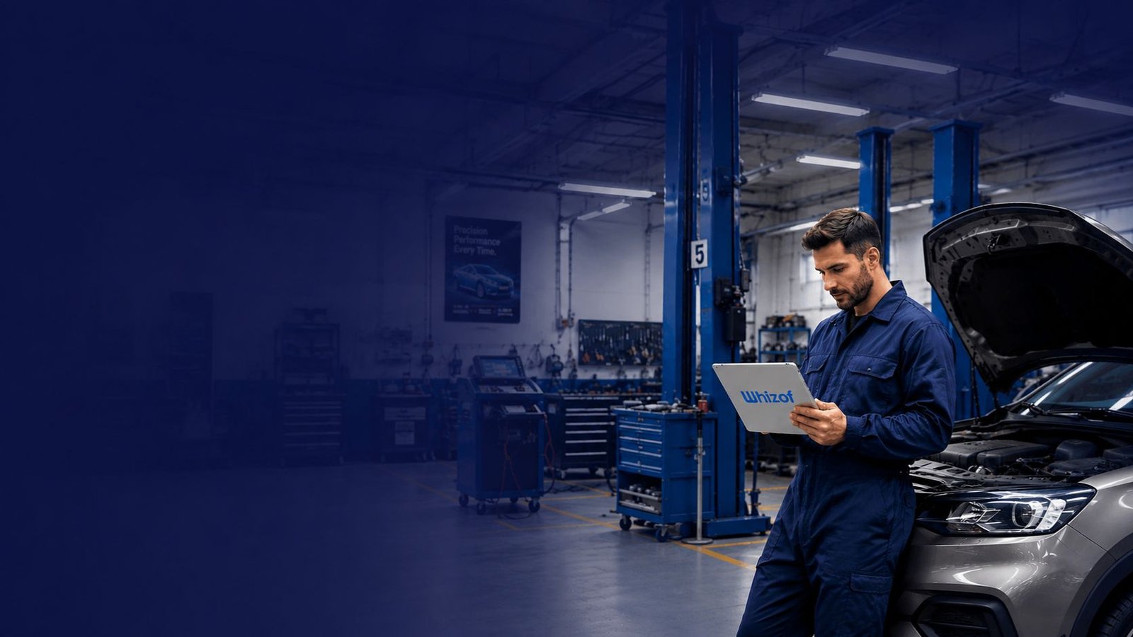 Mechanic using Whizof on a tablet in a modern UK garage